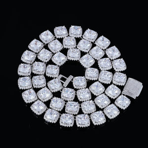 Full‑length coiled flat‑lay view of 10MM Glacier Cushion Clustered Tennis Chain in White Gold, whole necklace neatly coiled showing complete row of hand‑set VVS simulated cushion diamonds with clustered halo setting, fully iced pave lock clasp hardware visible, premium icy bling men hip hop jewelry shot on solid black background RDRIP JEWELRY
