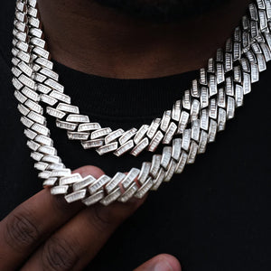 14MM Baguette Channel‑Set Miami Cuban Link Necklace,18K white gold plated iced‑out men hip hop chain,hand‑set flawless VVS simulated baguette stones,two‑layer stacked necklace on deep skin tone model,hand gently touching cuban chain links to showcase stone details,black crew neck top background,high‑end bling rapper streetwear statement jewelry RDRIP JEWELRY