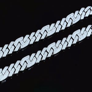 Macro texture close‑up of two 15mm prong‑set baguette mixed‑stone iced cuban curb chains in white gold finish, densely hand‑set VVS simulated baguette and round cut diamonds, full iced‑out heavy curb link details shot against solid black background, premium men hip‑hop streetwear bling jewelry RDRIP JEWELRY