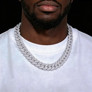16MM Rect Baguette Cuban Link Chain worn on black man model with light beard, iced‑out mixed rectangular baguette and round flawless VVS simulated diamonds hip hop necklace, white gold plated heavy mens miami cuban chain, luxury rapper bling jewelry against solid black background, RDRIP JEWELRY