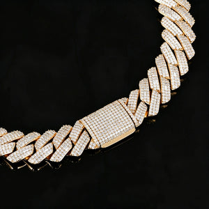 Extreme close-up studio product shot of 19mm full iced out prong set rectangular baguette cuban link chain in polished 18K gold plating, heavy men hip hop bling necklace with flawless VVS simulated diamond stones, ultra detailed fully micro pave diamond encrusted box clasp, laid on glossy black reflective mirror surface with natural soft mirror reflection, solid copper base hand-set stone streetwear statement jewelry close up detail photo RDRIP JEWELRY