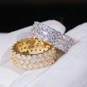 3‑Row Fully Paved Iced Out Eternity Ring stacked gold plated and white gold plated hip hop eternity band rings resting on white cotton glove, 8mm width full wrap band, hand‑set 4MM flawless VVS CZ simulated diamonds, heavy micro pave icy bling men women hip‑hop jewelry, brilliant sparkling full paved simulated diamond rings studio close‑up RDRIP JEWELRY SINCE 2016