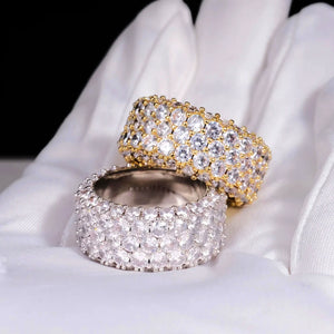 RDRIP JEWELRY 5‑Row Fully Paved Iced Out Eternity Ring placed on white soft cotton glove, heavy 14mm width prong‑set hip hop eternity band ring, gold‑toned and silver‑toned two finish, full‑circle hand‑set flawless VVS simulated diamonds, brilliant all‑angle shine, premium 18K & white gold plated icy bling jewelry for men women, Prong Cuban family statement hip‑hop ring