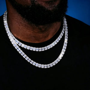 Close‑up shot of 8mm Iced Baguette Cluster Tennis Chain double layer layering set on black male model with short beard wearing black shirt, hand‑set mixed baguette and round VVS simulated CZ stones, brilliant iced‑out hip hop unisex bling necklace against deep dark blue studio background RDRIP JEWELRY
