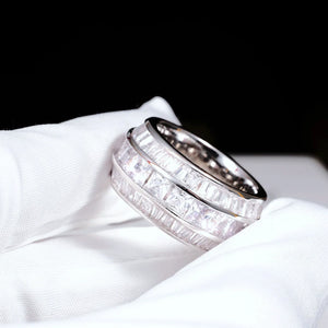Handheld close‑up detail shot of white gold plated Baguette Square Triple Row Ring held in white microfiber glove, 12mm wide men hip hop band ring, hand set flawless VVS simulated baguette and square cut stones full pavé heavy icy bling mens statement ring RDRIP JEWELRY