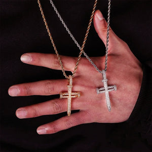 Hand held size reference shot of Iced Out Nail Cross Pendant, 18k gold plated and silver tone full pave AAA cubic zirconia nail crucifix necklaces with rope chain for men, showing real product dimension against dark fabric background RDRIP JEWELRY