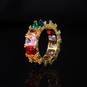RDRIP JEWELRY Iced Out Rainbow Baguette Eternity Ring gold plated side angle product shot showing inner band structure vibrant multicolor baguette cut cubic zirconia full band hip hop bling ring on black reflective background unisex urban statement jewelry