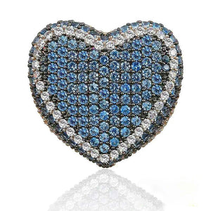 Macro close‑up studio shot of icy blue iced out pave love heart ring, densely hand‑set AAA cubic zirconia blue gemstones framed by sparkling clear CZ border, full micro pave heart‑shaped hip hop bling statement ring, subtle soft reflection on clean isolated white background, heavy unisex street rapper fashion jewelry for men and women RDRIP JEWELRY