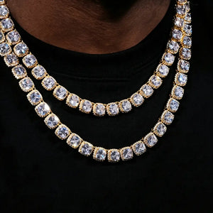 Close‑up layered stacked view of 10MM Glacier Cushion Clustered Tennis Chain in 18K Gold, men’s iced‑out hip hop necklace set with flawless VVS cushion‑cut simulated diamonds, hand prong‑set bling cluster stones, deep dark skin male model, solid clean black background, luxury unisex statement hip‑hop jewelry for layering outfits RDRIP JEWELRY