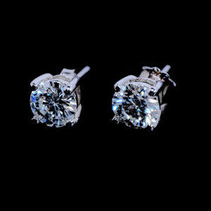 Minimalist Solitaire Round Moissanite Stud Earrings, 4-prong setting D-E color VVS1 hearts and arrows round moissanite, 925 sterling silver white gold plated unisex hip hop single stone earrings front close-up shot on solid black background RDRIP JEWELRY