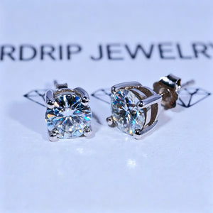 Minimalist Solitaire Round Moissanite Stud Earrings, 4-prong setting D-E color VVS1 hearts and arrows round moissanite, 925 sterling silver white gold plated screw back unisex hip hop single stone earrings against branded white background RDRIP JEWELRY