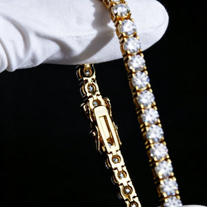 Extreme macro closeup shot of S925 sterling silver 18K gold plated 4MM round VVS1 D color moissanite tennis bracelet, detailed double safety lock clasp engraved S925 stamp, held by clean white jewelry gloves on solid pure black background, clear close view of hand-set sparkling moissanite stones with brilliant rainbow fire shine, unisex hip hop iced out luxury wrist chain for men women, stackable streetwear bling jewelry, durable anti-tarnish gold finish, 7in 8in size options, RDRIP JEWELRY established 2016