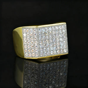 Angled side view of two‑tone gold silver men hip hop full pave square statement band ring by RDRIP JEWELRY, thick polished gold band with densely hand‑set cubic zirconia and rhinestone pave stones, 18k gold plated copper heavy iced‑out bling mens hip‑hop statement ring, black glossy reflective studio product photography