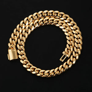 Flat lay studio shot of coiled 12.2mm 18k gold plated Miami Cuban link chain with solid box lock clasp, thick tight interlocking polished cuban links, shiny reflective anti-tarnish gold finish, heavy weight men hip hop curb chain laid neatly on matte black solid background, clear close view of secure box clasp mechanism, premium streetwear bling jewelry for men, timeless stackable gold cuban necklace product detail shot RDRIP JEWELRY SINCE 2016