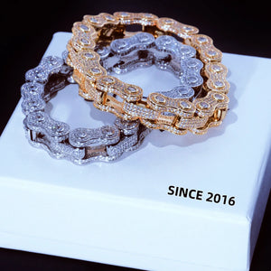 11mm full iced out bike chain link bracelet stack display, 18k gold plated and white gold plated two color motorcycle biker wrist jewelry, fully encrusted flawless VVS simulated diamonds hand-set without glue for maximum bling shine, two bracelets layered on clean white brand gift box printed SINCE 2016, heavy drip hip hop streetwear statement bracelet for men available in 7 inch and 8 inch sizes luxury fashion men jewelry gift RDRIP JEWELRY