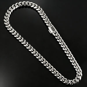 Top-down studio flat lay photo of full length 12.2mm polished 14k white gold plated Miami Cuban link chain with sturdy rectangular box lock clasp, seamless solid black single-piece reflective mirror backdrop with zero color blocks, thick tight interlocking curb links, mirror-like shiny silver anti-tarnish finish, heavy solid metal plain hip hop curb necklace for men, no stones minimalist luxury men bling jewelry product shot RDRIP JEWELRY SINCE 2016