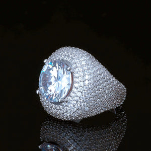 Men hip hop Glory Dome Iced Clustered Band Ring profile view, large round brilliant cut center stone, layered micro pave hand‑set VVS flawless simulated diamonds dome band, 18K white gold plated heavy bling statement ring for men, luxury hip‑hop jewelry on black reflective background RDRIP JEWELRY