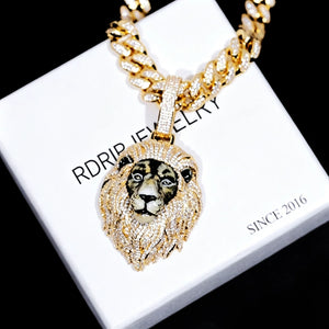 Gold iced out 3D enamel painted lion king pendant placed on branded gift box, realistic hand‑painted lion face, full vvs simulated diamond encrusted mane, hip hop men statement jewelry RDRIP JEWELRY