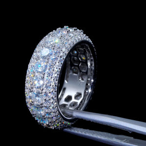 Side profile close‑up view of layered pave full iced‑out men eternity band ring held by professional jewelry tweezers, hand‑set VVS1 D‑color hearts and arrows round moissanite gemstones, 9mm wide S925 sterling silver white gold plated hip‑hop bling ring, detailed hollow honeycomb inner band structure, brilliant rainbow light reflection against solid black background, premium men streetwear statement jewelry, RDRIP JEWELRY