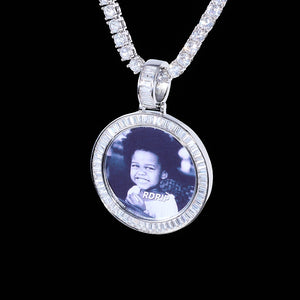 Baguette Iced Out Round Custom Photo Pendant Necklace, white gold tone pendant with baguette-cut stone frame, custom black-and-white child portrait photo, hanging tennis chain on solid black background, personalized hip hop memory jewelry, RDRIP JEWELRY