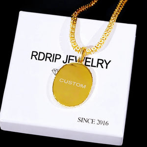 Gold Oval Halo Custom Photo Pendant Necklace back view, engraved CUSTOM text on polished gold oval medallion, displayed on white RDRIP JEWELRY gift box with SINCE 2016 print, studio shot on solid black background, personalized hip hop custom memory jewelry