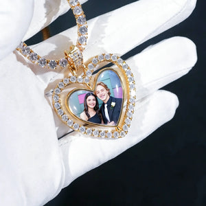 Iced Out Double Sided Rotatable Heart Custom Photo Pendant, gold tone held in white gloved hand, prom couple custom photo inside heart frame, encrusted round stones, matching tennis chain, dark background personalized love photo locket necklace, RDRIP JEWELRY
