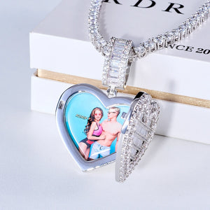 Iced Out Heart Locket Custom Photo Pendant Necklace, white gold tone open heart locket with custom couple portrait photo inside. Fully encrusted heart lid with round and baguette cut stones, paired tennis chain displayed on official RDRIP branded white gift box, light background commercial shot, openable personalized hip hop keepsake jewelry, RDRIP JEWELRY