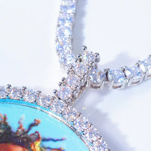 VVS MOISSANITE LARGE 3D CIRCLE CUSTOM PICTURE PENDANT, macro close-up view of silver plated VVS moissanite encrusted bail and stone border frame, matched with iced out tennis chain, premium hip hop jewelry detail shot on clean plain white surface, RDRIP JEWELRY