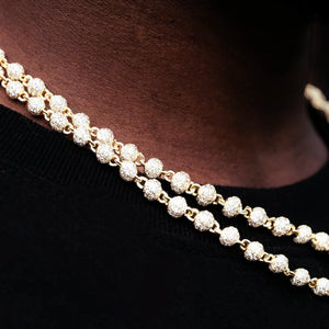 Macro close‑up detail shot of layered RDRIP 4mm Iced Stellar Ball Bead Chain, 18K gold plated men hip hop necklace, densely set flawless VVS simulated diamonds on round ball bead links, showing sparkling stone craftsmanship while worn on neck with black shirt, premium iced‑out street fashion jewelry, RDRIP JEWELRY SINCE 2016