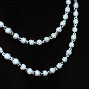 Close‑up detail shot of RDRIP 4mm Iced Stellar Ball Bead Chain on black fabric background, white gold plated hip hop men necklace, each round ball fully paved with flawless VVS simulated diamonds, showcase intricate bead link construction and brilliant sparkling effect, streetwear iced‑out fashion jewelry, RDRIP JEWELRY SINCE 2016