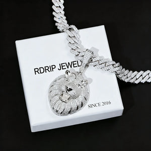 Silver tone iced out roaring king lion head pendant necklace, full pave flawless VVS simulated diamonds men hip hop bling jewelry laid on branded gift box pure black background RDRIP JEWELRY