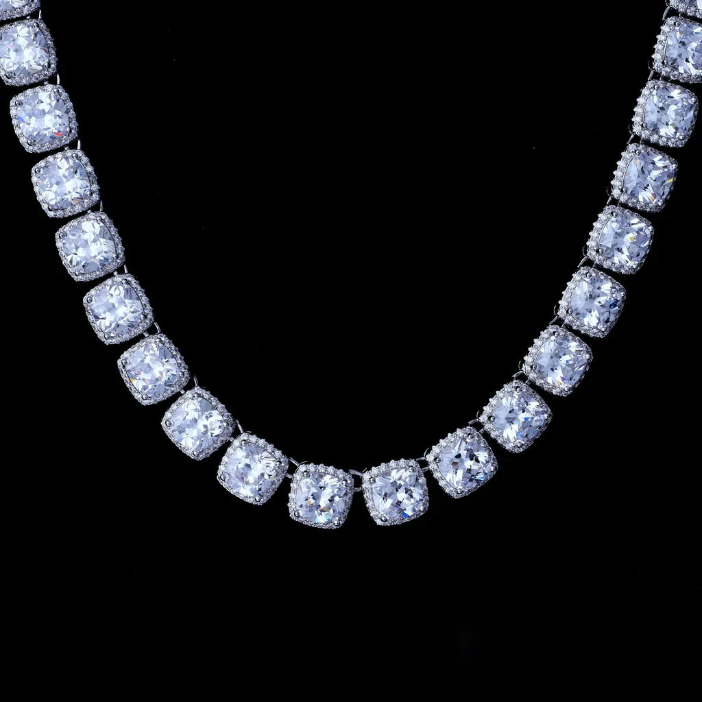 Macro close‑up shot of 10MM Glacier Cushion Clustered Tennis Chain in White Gold, hand‑set VVS flawless simulated cushion diamonds with clustered halo micro pave setting, icy bling hip hop tennis chain necklace flat lay on solid black studio background showcasing brilliant stone sparkle RDRIP JEWELRY