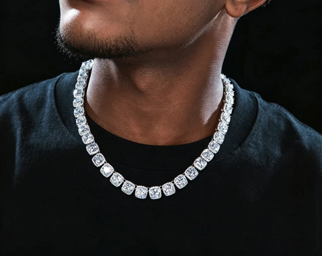 10MM Glacier Cushion Clustered Tennis Chain in White Gold close‑up men model wearing shot, iced‑out cushion cut clustered halo simulated diamond hip hop necklace for men, premium icy bling mens jewelry against dark black background RDRIP JEWELRY
