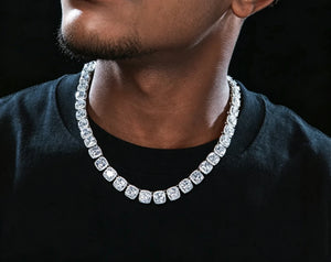 10MM Glacier Cushion Clustered Tennis Chain in White Gold close‑up men model wearing shot, iced‑out cushion cut clustered halo simulated diamond hip hop necklace for men, premium icy bling mens jewelry against dark black background RDRIP JEWELRY
