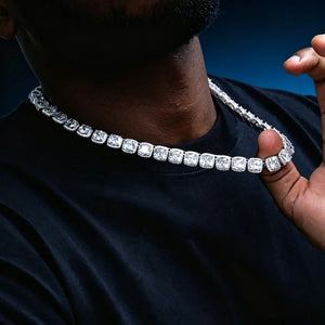 Side profile neck focus shot, male model wearing 10MM Glacier Cushion Clustered Tennis Chain in White Gold, hand‑set VVS simulated cushion diamonds with clustered halo pave setting, icy bling hip hop mens necklace displayed on neck, dark blue gradient studio background highlighting brilliant stone sparkle RDRIP JEWELRY
