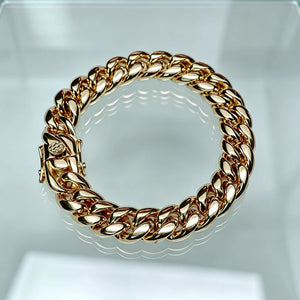 Polished heavy 12mm 18k gold plated classic Miami cuban link bracelet for men crafted with solid stainless steel base triple thick IP gold wrapping full gold coverage between chain links sturdy triple safety lock box clasp thick shiny gold cuban wrist chain realistic solid gold look weighty hip hop rapper daily wear jewelry tarnish resistant durable mens stacking wrist accessory premium affordable alternative to real solid 18k gold cuban bracelet available in 7 inch 8 inch lengths 106g heavy weight hip hop 