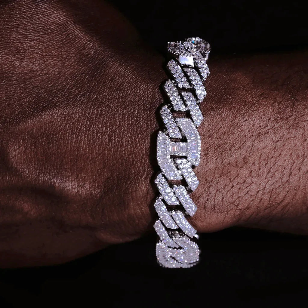 12mm Prong Set Iced Baguette Curb Bracelet White Gold Plated close up shot on dark skin man wrist, detailed view of hand prong set rectangular baguette VVS simulated diamonds on curb links, fully flooded icy bling thick mens curb wrist chain, full stone encrusted links and iced clasp, premium hip hop streetwear jewelry for men shiny reflective diamond curb bracelet RDRIP JEWELRY
