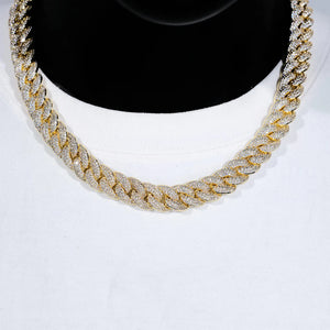 Front closeup studio photo of 14mm 3 row bubble dense fully paved iced miami cuban link chain 18k gold plated fully hand prong set flawless VVS simulated diamond heavy chunky hip hop men necklace displayed on black bust mannequin paired with plain white crew neck tee soft studio lighting ultra clear shiny stone details full encrusted bling rapper streetwear jewelry showcase RDRIP JEWELRY

