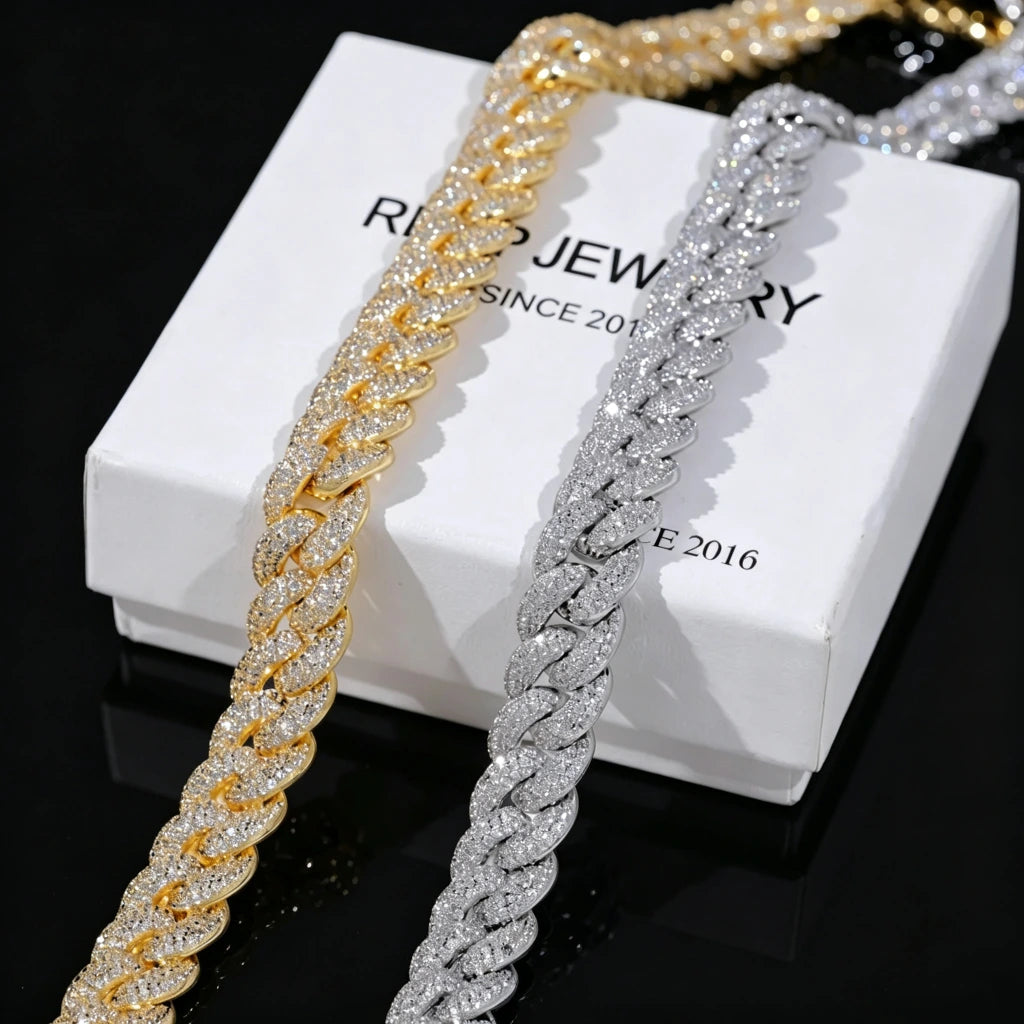 Flat lay shot of two 14mm 3 row bubble dense fully paved iced miami cuban link chains 18k gold plated and white gold plated fully encrusted flawless VVS simulated diamonds heavy chunky hip hop mens necklace placed side by side on branded white gift box printed RDRIP JEWELRY SINCE 2016 solid pure black background ultra high resolution clear shiny stone details hand prong set bling rapper street jewelry gift set showcase close up product photography RDRIP JEWELRY
