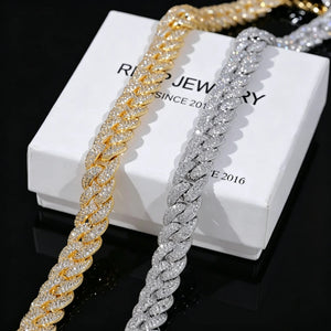 Flat lay shot of two 14mm 3 row bubble dense fully paved iced miami cuban link chains 18k gold plated and white gold plated fully encrusted flawless VVS simulated diamonds heavy chunky hip hop mens necklace placed side by side on branded white gift box printed RDRIP JEWELRY SINCE 2016 solid pure black background ultra high resolution clear shiny stone details hand prong set bling rapper street jewelry gift set showcase close up product photography RDRIP JEWELRY
