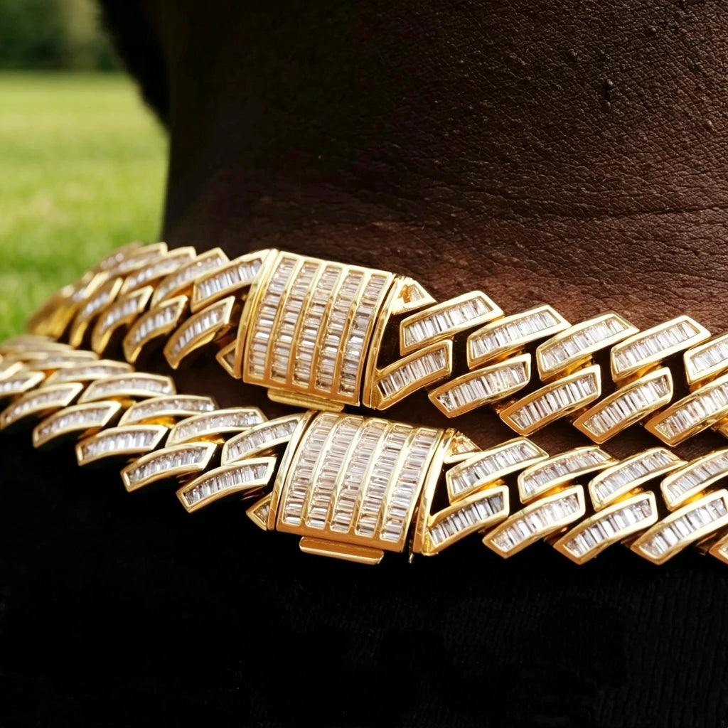 14MM Baguette Channel‑Set Miami Cuban Link Necklace macro close‑up shot,18K gold plated full iced‑out men hip hop chain,hand‑set flawless VVS simulated baguette stones,detailed view of fully encrusted box clasp lock,two stacked gold chains resting on deep dark skin neck,outdoor blurred green grass background,luxury heavy bling rapper streetwear jewelry RDRIP JEWELRY
