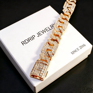 Close‑up view of the clasp on 14mm gold plated iced out geometric polygon cuban link bracelet for men, hollow multi‑sided links prong‑set with flawless VVS simulated CZ diamonds, micro pave icy hip hop bling jewelry, bracelet lock detailed shot, laid on RDRIP JEWELRY branded card printed SINCE 2016 with black background, heavy baller rapper statement wrist bracelet RDRIP JEWELRY
