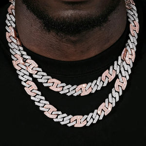 Close‑up layered worn shot of two 14mm iced prong two‑tone cuban choker necklaces for men, white and pink two‑tone finish, hand‑set flawless VVS simulated diamonds, heavy solid copper 18K gold plated icy hip hop bling chains, stacked streetwear party jewelry on black man neck RDRIP JEWELRY
