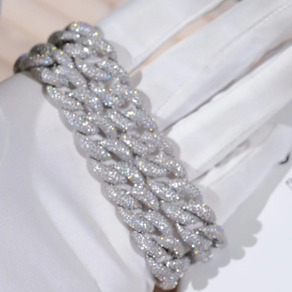 15mm 5-Row Fully Paved Iced Cuban Link Bracelet for men, silver tone thick miami curb wrist chain fully encrusted brilliant VVS D color moissanite stones, full pave all over diamond bling hip hop bracelet, ultra sparkling icy cuban wrist jewelry close macro shot held by soft white cotton gloves, heavy solid wide curb link rapper streetwear accessory, high clarity shimmer lab diamond encrusted mens statement bracelet, polished silver finish luxury hip hop gift for him, dazzling full stone pave icy cuban 