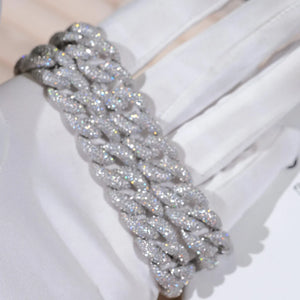 15mm 5-Row Fully Paved Iced Cuban Link Bracelet for men, silver tone thick miami curb wrist chain fully encrusted brilliant VVS D color moissanite stones, full pave all over diamond bling hip hop bracelet, ultra sparkling icy cuban wrist jewelry close macro shot held by soft white cotton gloves, heavy solid wide curb link rapper streetwear accessory, high clarity shimmer lab diamond encrusted mens statement bracelet, polished silver finish luxury hip hop gift for him, dazzling full stone pave icy cuban 