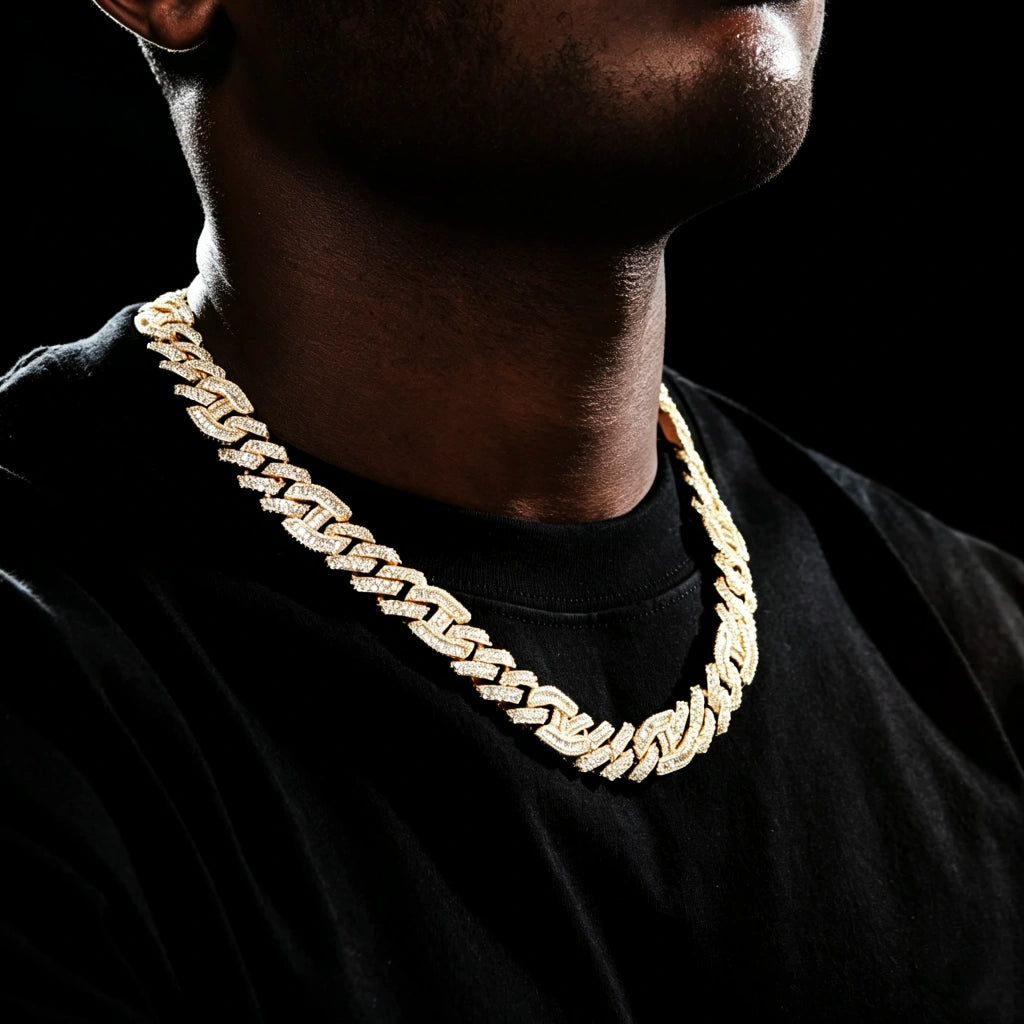 Side angle wearing shot of 15mm prong‑set mixed‑stone iced cuban curb chain on dark skin black man with very short light stubble beard, model in plain black t‑shirt on dark studio background, 18K gold plated pure copper men hip hop necklace, hand‑set baguette cut and round VVS simulated diamonds, full iced‑out heavy curb link streetwear bling jewelry RDRIP JEWELRY
