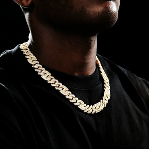 Side angle wearing shot of 15mm prong‑set mixed‑stone iced cuban curb chain on dark skin black man with very short light stubble beard, model in plain black t‑shirt on dark studio background, 18K gold plated pure copper men hip hop necklace, hand‑set baguette cut and round VVS simulated diamonds, full iced‑out heavy curb link streetwear bling jewelry RDRIP JEWELRY
