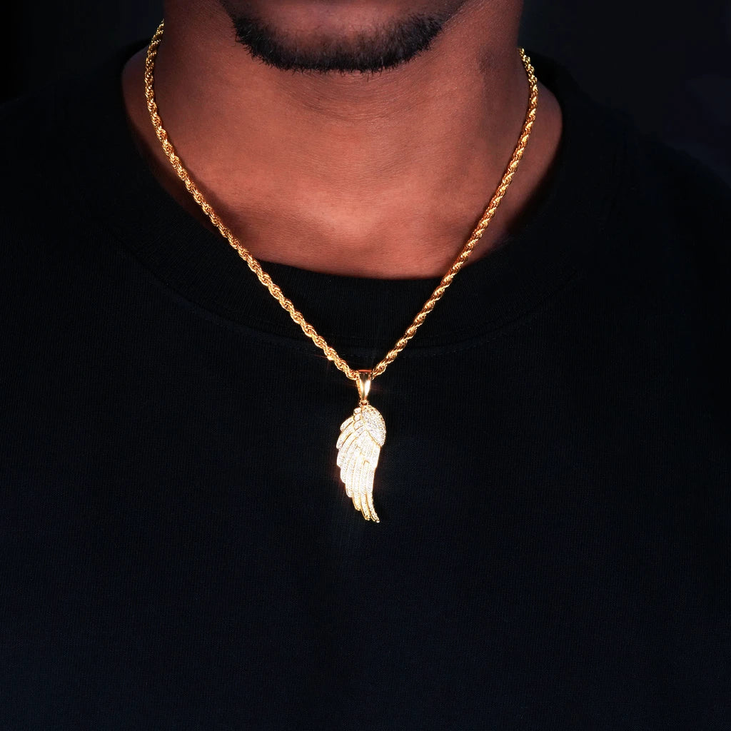 Close‑up neck worn shot of 15mm Iced Micro‑Paved Single Seraph Wing Pendant in yellow gold tone, matched with gold rope chain, fully micro paved sparkling cubic zirconia feather wing charm, men hip‑hop street jewelry on black tee, dark studio background, RDRIP JEWELRY
