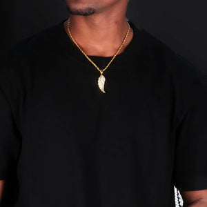 Upper‑body model wearing view of 15mm Iced Micro‑Paved Single Seraph Wing Pendant yellow gold tone, paired with gold rope chain, micro‑set cubic zirconia feather wing charm, men hip‑hop street necklace on plain black t‑shirt, dark solid studio background, RDRIP JEWELRY
