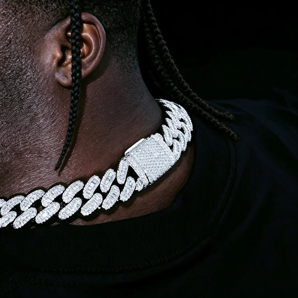 Side close‑up view of the buckle clasp on 16MM Rect Baguette Cuban Link Chain, worn by dark‑skin black man with short neat braids hairstyle, iced‑out mixed rectangular baguette and round flawless VVS simulated diamonds, white gold plated heavy miami cuban hip hop necklace, showing fully encrusted stone‑filled lock detail, dark studio solid black background, RDRIP JEWELRY
